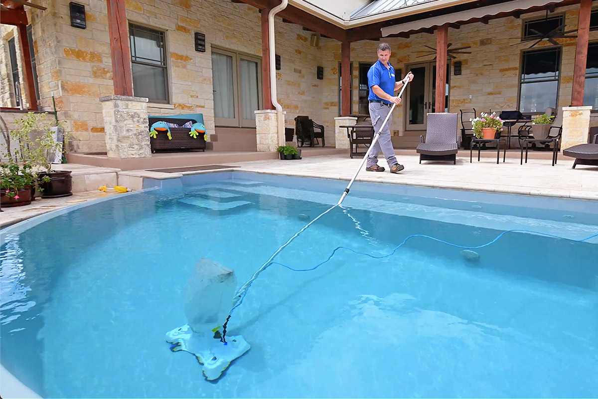 1200×800-PoolPro-01 Swimming pool equipment being used to clean a pool