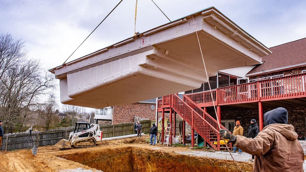 Inground fiberglass swimming pool installation An inground fiberglass pool is being lifted