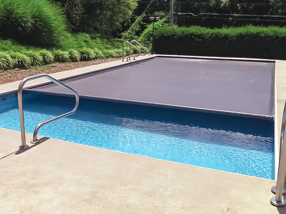 051223-SafetyEquipment-1 An automatic pool safety cover adds an extra layer of security to your backyard fiberglass pool