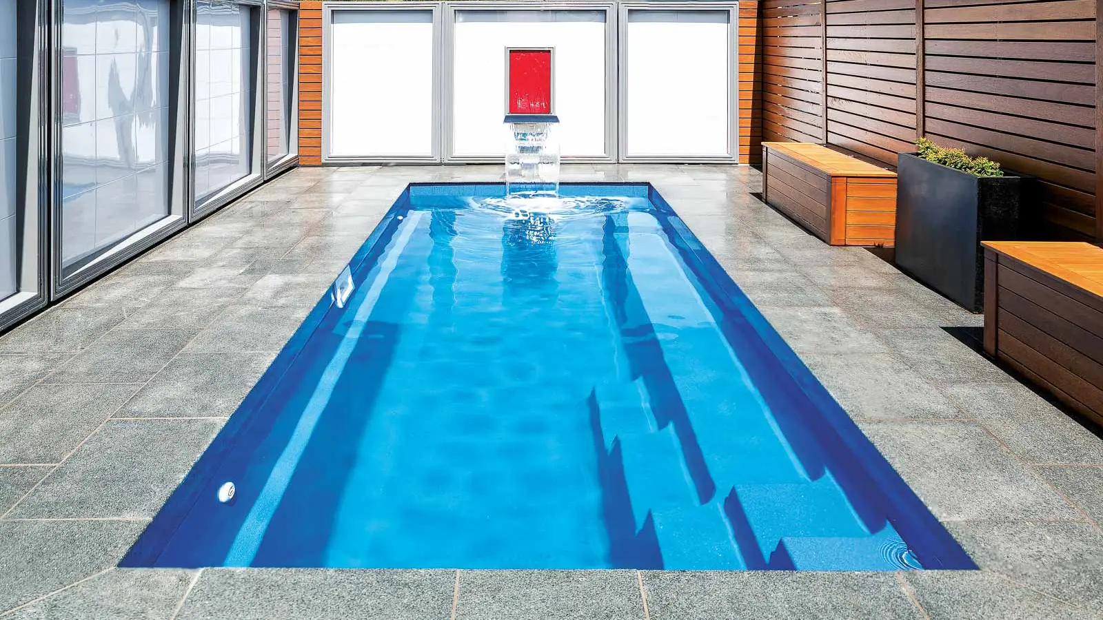 Leisure-Pools-Esprit-fiberglass-pool The Esprit, a fiberglass pool with full length bench seating