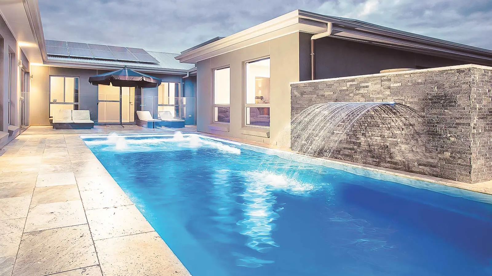 Leisure-Pools-Reflection-including-Splash-Deck-fiberglass-pool The Reflection including Splash Deck, a fiberglass pool with full-length bench seating and a splash deck