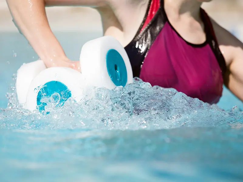 LPBlog-HealthyHabits-2 arm lists with weights in a fiberglass swimming pool