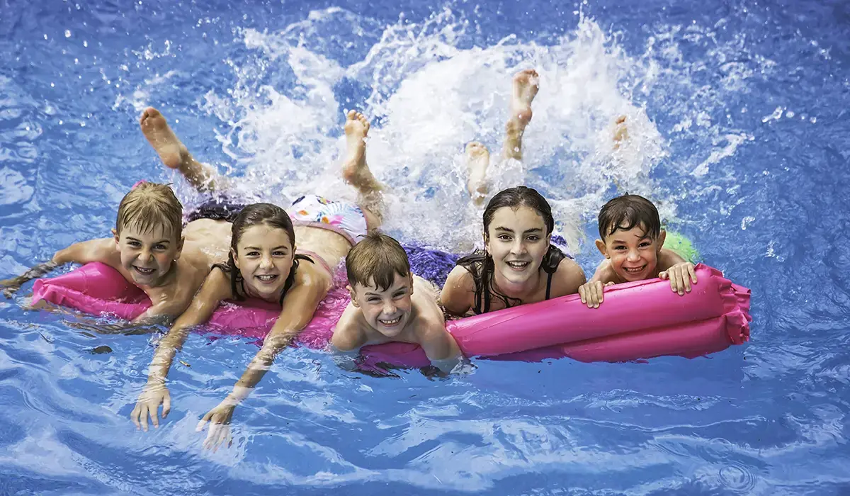 Pool Party Hero Back to School pool party in a fiberglass inground swimming pool